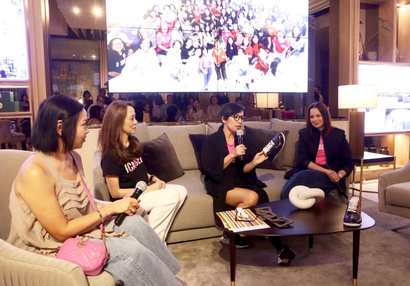 Crisann Celdran and Carmina Sanchez Jacob flank ICanServe Foundation’s Kara Magsanoc-Alikpala (2nd from left) and artist Christina Dy (center) as she talks about her design.